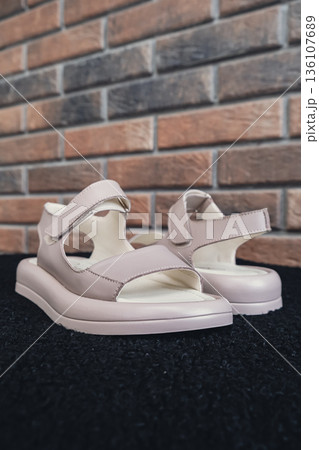 Elegant beige leather women sandals blank product for summer fashion branding and premium product showcases. Modern casual design and soft leather texture retail, e-commerce catalogs. No-brand Elegant beige leather women sandals blank product for summer fashion branding and premium product showcases. Modern casual design and soft leather texture retail, e-commerce catalogs. No-brand 136107689