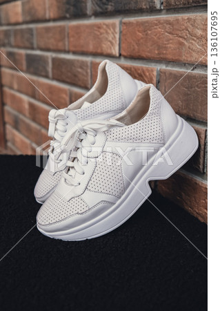 Fresh beige leather sneakers without brand marks displayed. For design templates online shops and sustainability-themed marketing. Clean blank sneakers 136107695
