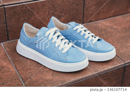 Elegant blue leather womens shoes blank product for branding displayed. New casual female sneakers no-brand footwear e-commerce. No logo product unbranded fashion 136107714