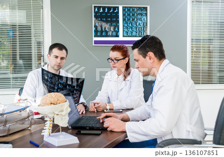 Doctors team having medical council in hospital. Doctors team having medical council in hospital. 136107851