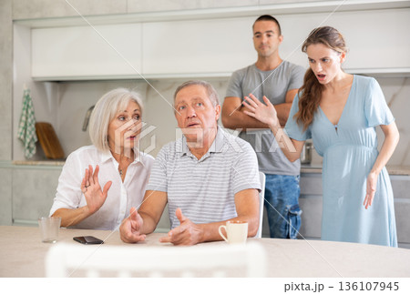 Family quarrel - couple is unhappy with elderly parents, express dissatisfaction 136107945