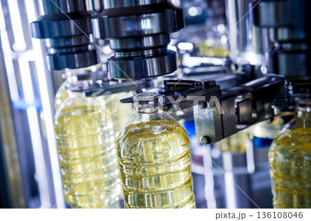 Bottling line of sunflower oil in bottles. Vegetable oil production plant Bottling line of sunflower oil in bottles. Vegetable oil production plant 136108046