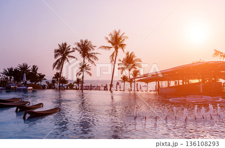 Beautiful tropical beach restaurant with palm trees. Sunrises and sunsets.  136108293