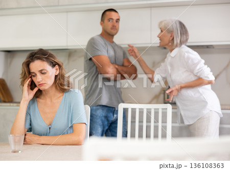 Young girl with her mother-in-law and husband 136108363