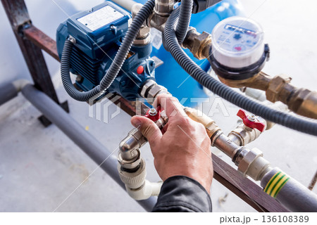 Technician checking water system nodes.Modern Industrial background 136108389