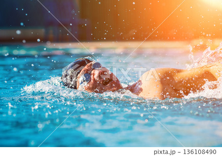 Young athletic man swimming in the swimming pool Young athletic man swimming in the swimming pool 136108490