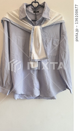 Clothes hanging neatly on hangers under the sun, gently swaying in the breeze—offering a perfect glimpse of fresh laundry days, clean fabric, and simple everyday beauty in every scene. 136108677