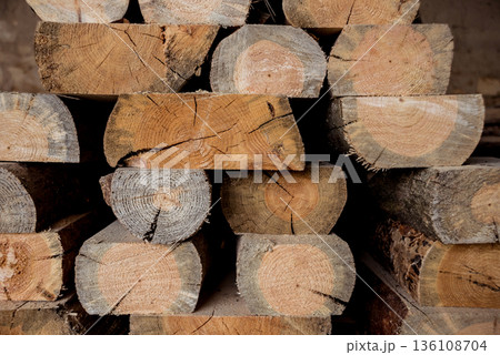 Stack of natural rough wooden boards. Wooden boards, lumber, industrial wood. Stack of natural rough wooden boards. Wooden boards, lumber, industrial wood. 136108704