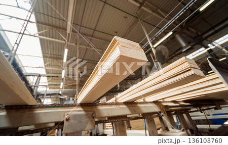 Production line of the wooden floor factory. CNC automatic woodworking machine. Production line of the wooden floor factory. CNC automatic woodworking machine. 136108760