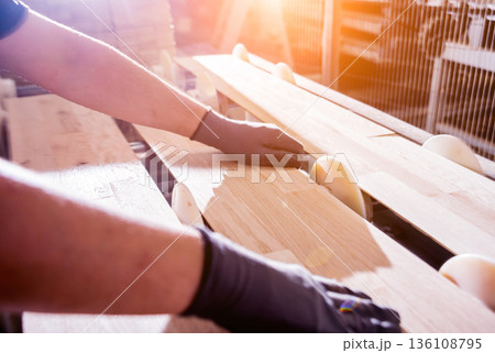 Carpenter with fibreboards at furniture factory workshop. Woodworking industry 136108795