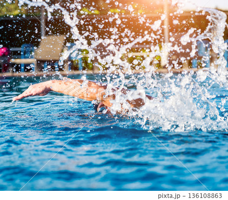 Young athletic man swimming in the swimming pool Young athletic man swimming in the swimming pool 136108863