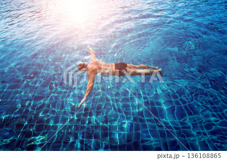 Young athletic man swimming in the swimming pool Young athletic man swimming in the swimming pool 136108865
