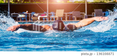 Young athletic man swimming in the swimming pool Young athletic man swimming in the swimming pool 136108871