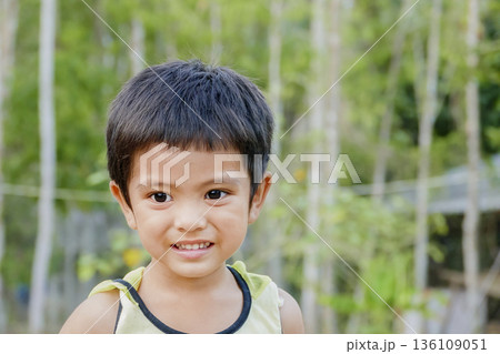 Closeup cute portrait of Asian little boy smiling outdoor Closeup cute portrait of Asian little boy smiling outdoor 136109051