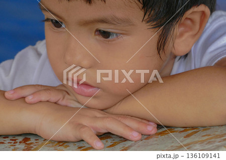 Closeup cute portrait of Asian little boy absent-minded 136109141