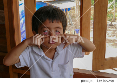 Asian Thai little boy make grimace eyes act like a ghost Asian Thai little boy make grimace eyes act like a ghost 136109296