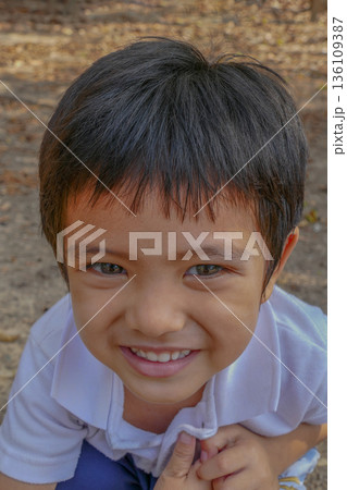 Closeup cute portrait of Asian little boy smiling outdoor Closeup cute portrait of Asian little boy smiling outdoor 136109387