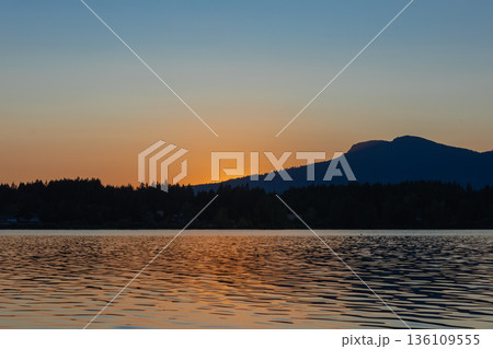 Evening sunset leaving behind a mountain on the beautiful coast of the Vancouver Island BC. 136109555