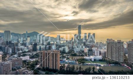 Warm Sunset Illuminates Yau Tsim Mong Skyline And Harbour 136110253