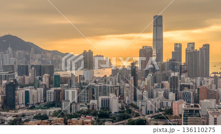 Warm Sunset Illuminates Yau Tsim Mong Skyline And Harbour 136110275