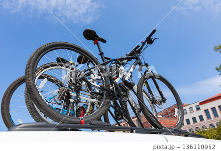 Bicycles on the rack on top of the car with bicycles. 136110952