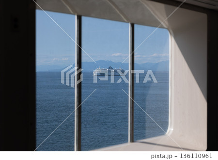 The view through ferry ship window across a sea to another ferry going to Vancouver Island. The view through ferry ship window across a sea to another ferry going to Vancouver Island. 136110961