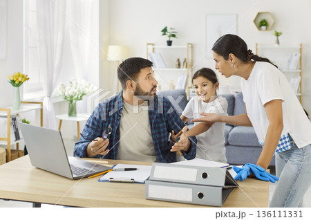 Tired father with stress working at home, mother and child disturb busy dad Tired father with stress working at home, mother and child disturb busy dad 136111331