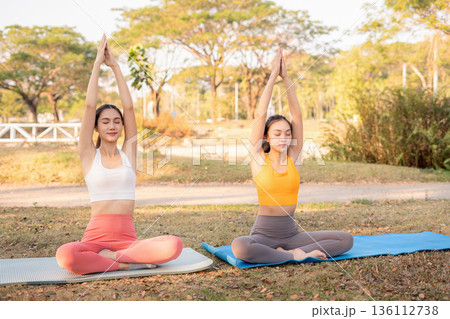 Fit woman practicing yoga outdoor. Calmness and relax. fitness, yoga training, lifestyle. Fit woman practicing yoga outdoor. Calmness and relax. fitness, yoga training, lifestyle. 136112738