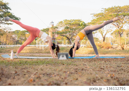 Fit woman practicing yoga outdoor. Calmness and relax. fitness, yoga training, lifestyle. Fit woman practicing yoga outdoor. Calmness and relax. fitness, yoga training, lifestyle. 136112791