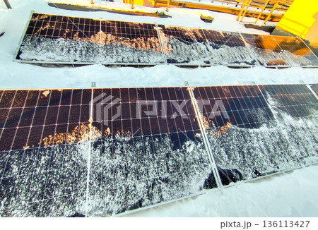 Solar panels in snow. Generating electricity during winter. Solar panels in snow. Generating electricity during winter. 136113427