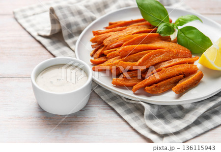 Sweet potato fries with dip, basil, and lemon 136115943