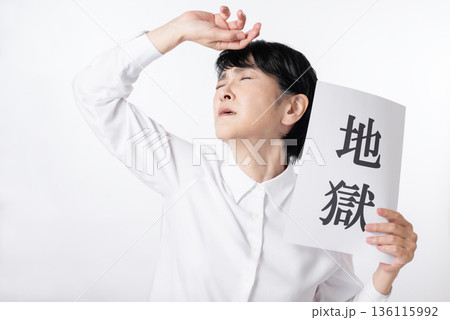 地獄と書かれた紙を持ち嘆き悲しむシニア女性 地獄と書かれた紙を持ち嘆き悲しむシニア女性 136115992