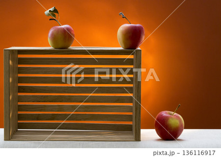 Still life with three apples and a wooden box 136116917