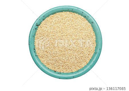 Organic white quinoa seeds in blue plate isolated on white background. Organic white quinoa seeds in blue plate isolated on white background. 136117085