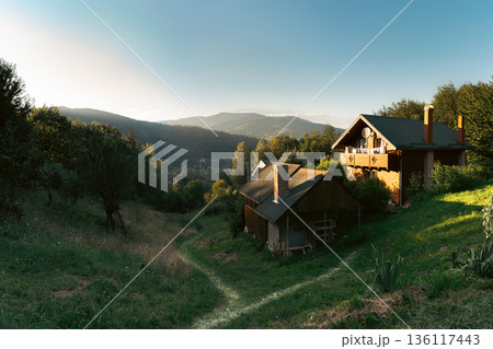Small Wooden House on Hillside at Sunset 136117443