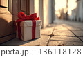 Late birthday gift with red ribbon left on doorstep 136118128