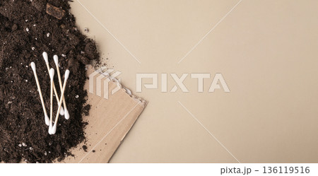 Biodegradable cotton swabs decomposing in soil with cardboard 136119516