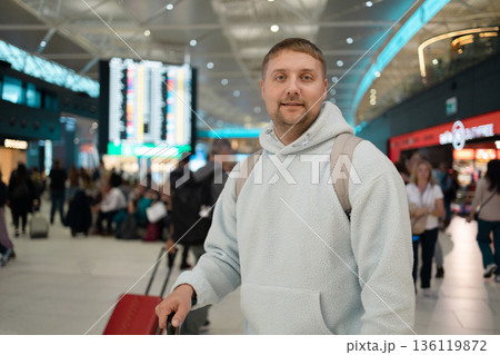 Male traveler walking with luggage at the modern airport terminal, man on way to flight boarding gate, Ready for travel or vacation journey, copy space Male traveler walking with luggage at the modern airport terminal, man on way to flight boarding gate, Ready for travel or vacation journey, copy space 136119872