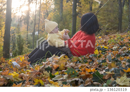 Mother and Baby Smiling in Autumn Park Mother and Baby Smiling in Autumn Park 136120319