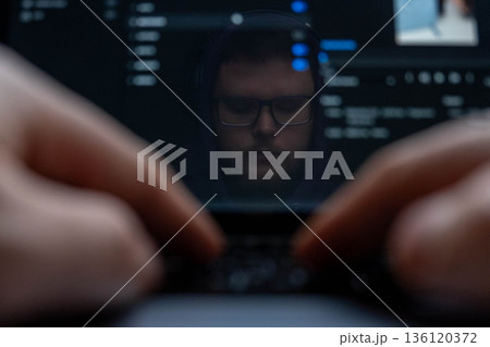 Man Reflection on Laptop Screen with Typing Hands Man Reflection on Laptop Screen with Typing Hands 136120372