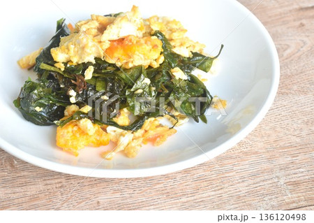 fried Melinjo tropical vegetable with egg on plate fried Melinjo tropical vegetable with egg on plate 136120498