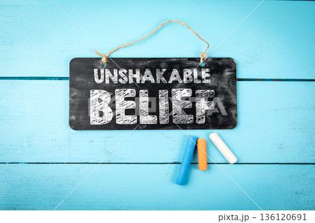 Unshakable Belief Concept Sign On Blue Wooden Background 136120691