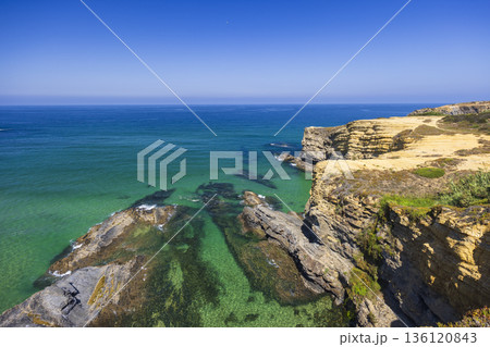 Clear Atlantic ocean water washing Odemira cliffs 136120843