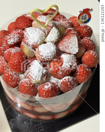 Strawberry cake with soft fluffy layers, topped with fresh strawberries and smooth cream, showcasing vibrant red fruit, delicate textures, and sweet inviting appearance in close-up detail 136122265