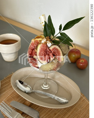 Smooth and creamy parfait layered with fresh fig slices, velvety yogurt, and crunchy granola. A perfect blend of natural sweetness, rich texture, and wholesome flavors for a refreshing dessert. 136122390