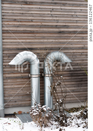 Ventilation pipes on wooden house exterior in winter Ventilation pipes on wooden house exterior in winter 136122467