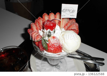 Healthy breakfast of strawberry parfait made with fresh fruit, and yogurt over a rustic white table. Selective focus with blurred background and foreground. 136122588