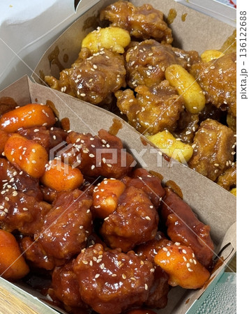 Crispy Korean fried chicken, perfectly glazed with a sweet and spicy sauce. Ideal for food photography and menus, showcasing the irresistible crunch and flavor of this beloved dish. Crispy Korean fried chicken, perfectly glazed with a sweet and spicy sauce. Ideal for food photography and menus, showcasing the irresistible crunch and flavor of this beloved dish. 136122688