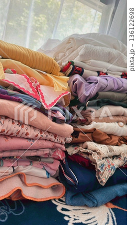 Clothes hanging neatly on hangers under the sun, gently swaying in the breeze—offering a perfect glimpse of fresh laundry days, clean fabric, and simple everyday beauty in every scene. 136122698