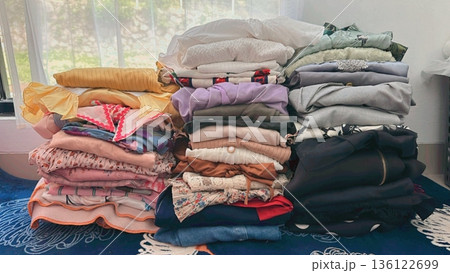 Clothes hanging neatly on hangers under the sun, gently swaying in the breeze—offering a perfect glimpse of fresh laundry days, clean fabric, and simple everyday beauty in every scene. 136122699